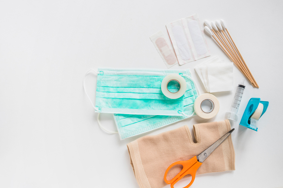 surgical-mask-bandage-gauze-cotton-swabs-sticky-bandage-knee-brace-with-scissor-white-background